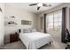 Inviting bedroom featuring a large window providing ample natural light and carpet flooring at 2030 W Whisper Rock Trl, Phoenix, AZ 85085