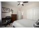 Comfortable bedroom with ceiling fan, closet, and a convenient study area at 2030 W Whisper Rock Trl, Phoenix, AZ 85085