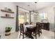 Cozy dining room features a wooden table, decorative shelves, and sliding glass doors to the backyard patio at 2030 W Whisper Rock Trl, Phoenix, AZ 85085