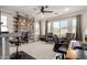 Versatile flex space with comfortable seating, shelving, and natural light from surrounding windows at 2030 W Whisper Rock Trl, Phoenix, AZ 85085