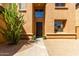 Charming home featuring a welcoming front door, green landscaping, and a well-lit entrance at 2030 W Whisper Rock Trl, Phoenix, AZ 85085