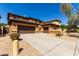 Well-maintained home with a three-car garage and neutral-colored exterior at 2030 W Whisper Rock Trl, Phoenix, AZ 85085