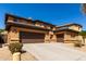 Well-maintained home with a three-car garage and neutral-colored exterior at 2030 W Whisper Rock Trl, Phoenix, AZ 85085