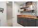 Mud room featuring wooden shelves and counter with gray cabinets and accent wall at 2030 W Whisper Rock Trl, Phoenix, AZ 85085