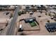 An aerial view shows the property, two homes, desert landscaping, privacy fencing, and nearby roads at 2242 E 12Th Ave, Apache Junction, AZ 85119