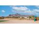 Backyard with desert landscaping, a patch of green lawn, and a playset at 2242 E 12Th Ave, Apache Junction, AZ 85119