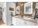Well-lit bathroom featuring a dual sink vanity with granite countertops and modern fixtures, complemented by wood accent wall at 2242 E 12Th Ave, Apache Junction, AZ 85119