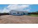 Single-story home with a graveled yard and landscaped with mountain views, and blue trim at 2242 E 12Th Ave, Apache Junction, AZ 85119