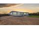 This home features a spacious gravel yard with desert landscaping and mountain views in the distance at 2242 E 12Th Ave, Apache Junction, AZ 85119