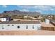 Backyard view with a wooden fence and mature shrubs and trees at 2242 E 12Th Ave, Apache Junction, AZ 85119