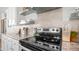 Close-up of a modern kitchen with stainless steel range and tile backsplash at 2242 E 12Th Ave, Apache Junction, AZ 85119
