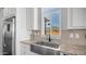 Modern kitchen sink with stainless steel faucet, light countertops, and view of the mountains at 2242 E 12Th Ave, Apache Junction, AZ 85119