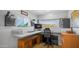 Home office space features large windows with views, a built-in desk, and ample natural light at 2242 E 12Th Ave, Apache Junction, AZ 85119