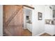 Open pantry with white cabinets and countertops, accessible through a sliding barn door at 2242 E 12Th Ave, Apache Junction, AZ 85119