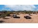 Spacious lot featuring a trailer, multiple vehicles, and outbuildings for storage at 2242 E 12Th Ave, Apache Junction, AZ 85119