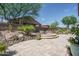 Inviting backyard featuring desert landscaping, a stone fire pit, and a well-maintained patio area at 22574 W Moonlight Path, Buckeye, AZ 85326