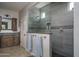 Modern bathroom featuring a glass-enclosed shower with designer tile, granite countertops, and updated fixtures at 22574 W Moonlight Path, Buckeye, AZ 85326