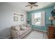Cozy bedroom with plenty of natural light from the large window and neutral decor at 22574 W Moonlight Path, Buckeye, AZ 85326