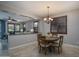 Open dining area with a round table, seating for four, and dark wood window shutters at 22574 W Moonlight Path, Buckeye, AZ 85326