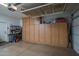 Organized garage space featuring ample built-in cabinetry and overhead storage racks at 22574 W Moonlight Path, Buckeye, AZ 85326