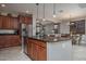 Open-concept kitchen with stainless steel appliances and an island open to living area at 22574 W Moonlight Path, Buckeye, AZ 85326