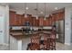 The kitchen features an island with pendant lighting, granite counters, and stainless steel appliances at 22574 W Moonlight Path, Buckeye, AZ 85326