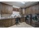 Laundry Room with custom cabinets and granite countertops, plus modern washer and dryer at 22574 W Moonlight Path, Buckeye, AZ 85326