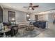 The living room offers a comfortable seating arrangement, neutral tones, and a ceiling fan at 22574 W Moonlight Path, Buckeye, AZ 85326