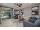 The living room features neutral colored walls, tiled flooring, and a ceiling fan at 22574 W Moonlight Path, Buckeye, AZ 85326