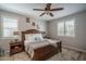 Comfortable main bedroom featuring a ceiling fan, neutral tones, and plentiful natural light from two windows at 22574 W Moonlight Path, Buckeye, AZ 85326