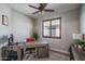Office with wood-style floors, a ceiling fan, and shuttered windows that let in plenty of natural light at 22574 W Moonlight Path, Buckeye, AZ 85326