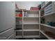 Organized pantry shelves offer ample storage space with a variety of containers and neatly arranged items at 22574 W Moonlight Path, Buckeye, AZ 85326
