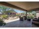 Inviting outdoor living space with a covered patio, comfortable seating, and a cozy fire pit at 22574 W Moonlight Path, Buckeye, AZ 85326