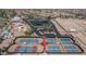 Aerial view of tennis courts, parking, and community center with solar panels in a Primary-planned community at 22574 W Moonlight Path, Buckeye, AZ 85326