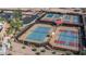 Well-maintained tennis courts with multiple courts and shaded seating areas at 22574 W Moonlight Path, Buckeye, AZ 85326