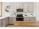 Well-equipped kitchen featuring light gray cabinets, stainless steel appliances, and quartz countertops at 23457 W Burton Ave, Buckeye, AZ 85326