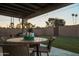 Cozy covered patio with a round table and chairs, offering a relaxing outdoor space at 236 E Minton Dr, Tempe, AZ 85282