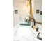White vanity with double sinks, gold hardware, black faucets and decorative accents at 236 E Minton Dr, Tempe, AZ 85282