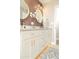 Stylish bathroom featuring double sinks with gold fixtures, modern lighting and decor at 236 E Minton Dr, Tempe, AZ 85282