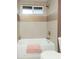 Bathtub and shower featuring bright tile and brushed gold fixtures at 236 E Minton Dr, Tempe, AZ 85282