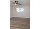 A bright bedroom with hardwood floors, ceiling fan and a large window at 236 E Minton Dr, Tempe, AZ 85282