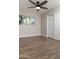 An empty bedroom with hardwood floors, a ceiling fan and window light at 236 E Minton Dr, Tempe, AZ 85282