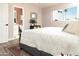 Well-lit bedroom with an upholstered bed, an ensuite bathroom, and a view of the lush outdoors at 236 E Minton Dr, Tempe, AZ 85282