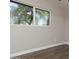 A bright bedroom with hardwood floors and a large window with backyard views at 236 E Minton Dr, Tempe, AZ 85282