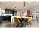 Open-concept dining area with modern kitchen and brick fireplace providing a welcoming and bright space at 236 E Minton Dr, Tempe, AZ 85282