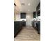 Well-designed kitchen featuring stainless appliances, dark cabinetry, a bright island, and modern flooring at 236 E Minton Dr, Tempe, AZ 85282