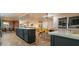 Spacious kitchen island with bar seating and modern light fixtures; open to the dining area and living spaces at 236 E Minton Dr, Tempe, AZ 85282