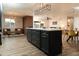 Elegant kitchen island with dark cabinetry, marble countertops, and an open flow to the living areas at 236 E Minton Dr, Tempe, AZ 85282