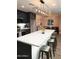 Bright kitchen features a large quartz island with seating, stainless appliances, and overlooks the living room at 236 E Minton Dr, Tempe, AZ 85282