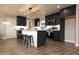 Spacious kitchen boasts modern appliances, dark cabinets, a bright island, and stylish bar stool seating at 236 E Minton Dr, Tempe, AZ 85282